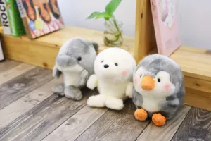 Cute animal plush toys detail scene showing soft dolphin, seal and penguin dolls together.