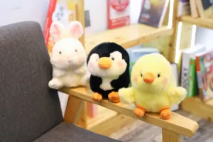 Cute plush toy set featuring a white rabbit, penguin, and yellow chick on wood shelf.