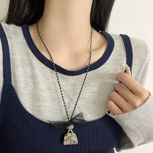 Detailed view of niche design lace bow bag pendant necklace, elegant women's choker.