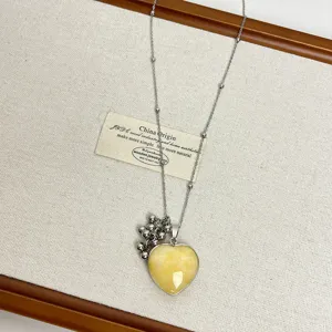 Long chain necklace with yellow heart pendant and metallic bead charm, stylish sweater chain.