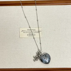 Long chain natural stone heart pendant necklace with beaded cluster detail for women.