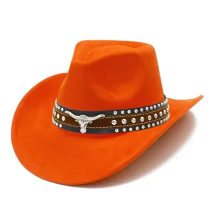 Close-up detail of orange suede western cowboy hat with metal bull skull and rivet studs.