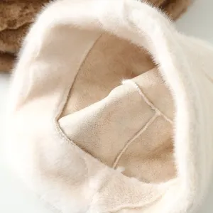 Detailed view of cozy winter bucket hat with plush faux fur trim and soft suede lining for warmth.