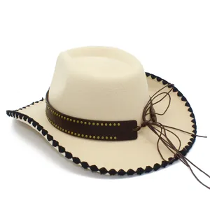 Detailed view of the beige western cowboy hat with brown studded band and black scalloped trim.
