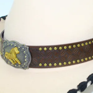 Western cowboy hat featuring a brown leather band and vintage horse buckle detail.