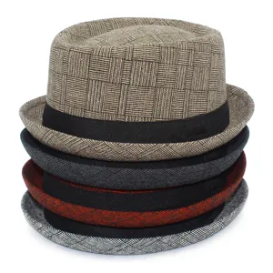 Detailed view of the classic plaid fedora hat showing textured fabric and black band style.