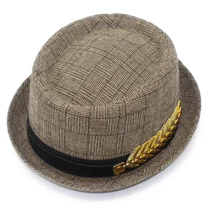 Detail view of men's woven fedora hat featuring classic black band and gold leaf metal accessory.