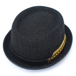 Detailed close-up of a stylish men's woven fedora hat with elegant black band and gold leaf decor.