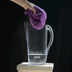 Detailed view of the soft purple microfiber towel demonstrating strong water absorption capacity.
