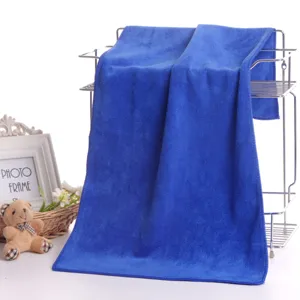 Detailed view of the blue microfiber face towel hanging on metal rack for salon and home use.