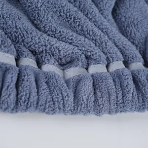 Soft coral fleece wearable bath towel close-up, highly absorbent bath skirt for adults.