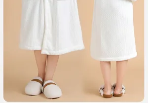 Vista detallada del albornoz de franela coral blanca y zapatillas suaves y comoda.