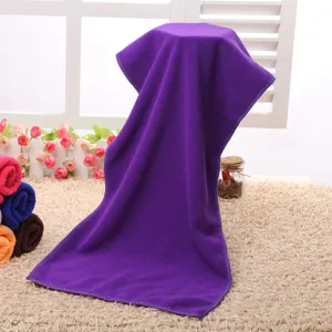 Detail view of a soft purple microfiber towel hanging for display, showing absorbent texture.