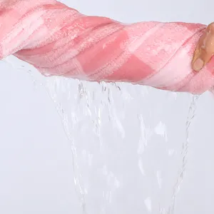 Pink coral fleece plaid bath towel showing high water absorption performance, soft and warm.