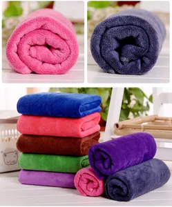 Microfiber towel detail showing soft texture, vibrant assorted colors, and high water absorption capacity.
