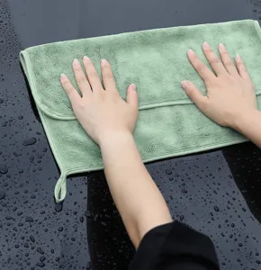 Detailed view of thick coral fleece car cleaning towel showing soft absorbent texture.