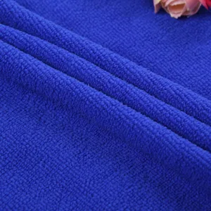 Close-up detail of blue microfiber towel fabric showing soft texture and fine weaving quality.