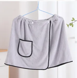 Grey wearable bath towel detail, soft absorbent fabric with pocket and snap buttons for home use.