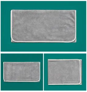 Detailed view of the grey beauty salon towel showcasing neat white piping design.