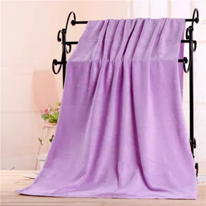 Large microfiber bath towel in light purple, displayed on a rack for home and salon use.