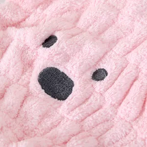 Close-up detail of pink coral fleece dry hair towel showcasing soft plush texture and embroidery.