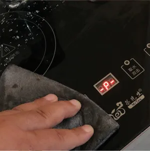 Detail view of the multi-functional cleaning cloth wiping glass surface, absorbent and soft.