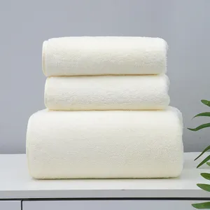 Coral fleece towel and bath towel set, stacked neatly in soft cream white, front view image.