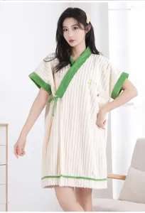 Detailed view of the soft coral fleece bath robe, cozy green trim and cute chest embroidery.