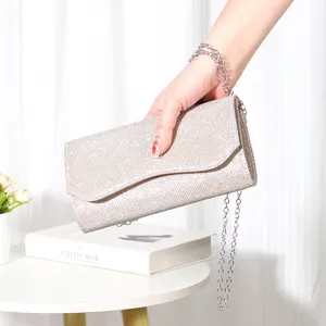 Shimmering glitter evening clutch bag with chain strap for women, elegant party handbag detail.