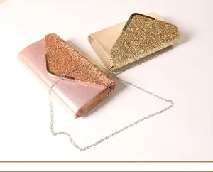 Detail view of stylish women's evening clutch bags featuring glitter flap and metal chain.