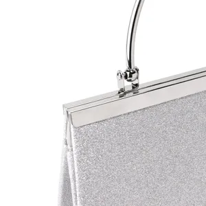 Silver glitter evening bag detail, metallic frame clasp and round metal handle presentation.