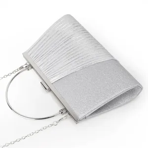 Silver glitter evening clutch bag detail, pleated design with metal round handle and chain strap.