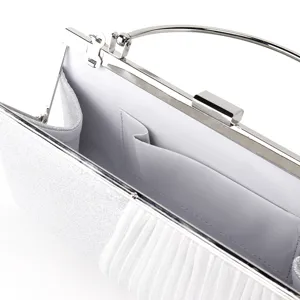 Detailed view of women's silver glitter evening clutch bag with metal clasp and inner pocket.