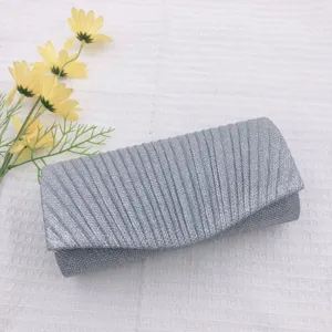 Silver glitter evening clutch bag, elegant pleated design for parties, weddings, and formal events.