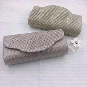Pleated glitter evening clutch bag detail view, elegant shimmering party handbag for women.