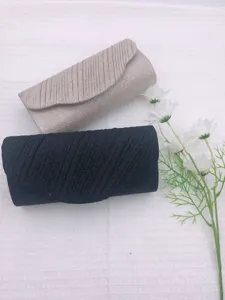 Elegant glitter evening clutch bag set with pleated design, champagne and black colors for party.