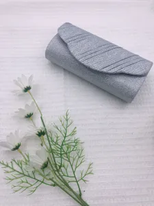 Detail view of the silver glitter evening clutch bag with elegant pleats and flap closure.