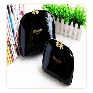 Black patent leather cosmetic bag set, waterproof makeup storage pouch with gold tone.