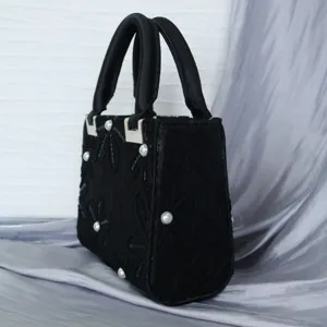Black Chinese style embroidered evening handbag featuring elegant pearl accents and top handles.