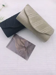 Elegant pleated evening clutch bag set for women, stylish party handbag in black and gold.