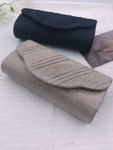 Detail view of glitter evening clutch bag, elegant black and gold design for party or wedding.