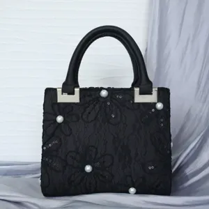 Exquisite black lace embroidered evening handbag featuring elegant pearl accents and top handle.