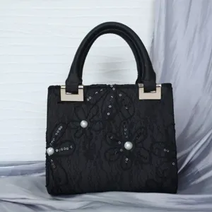 Elegant black lace evening handbag featuring pearls, sequins, and a chic top handle.