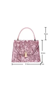 Pink velvet handbag detail showing precise dimensions, elegant metal clasp and handle.