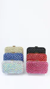 Close-up detail of sparkling rhinestone crystal evening clutch bags in vibrant colors.