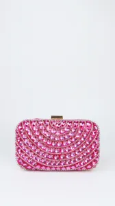 Close-up detail of the pink crystal evening clutch bag, showing shimmering rhinestones.