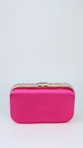 Detailed view of pink satin evening clutch with sparkling rhinestones and gold hardware.