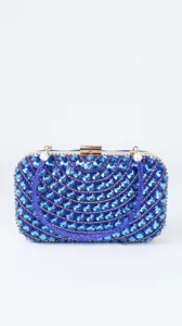 Detail view of blue rhinestone evening clutch, luxury crystal pattern and gold metal clasp frame.
