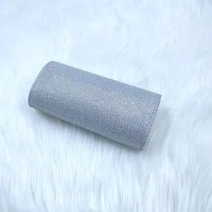 Elegant silver glitter cylindrical evening clutch bag detail view for women party.