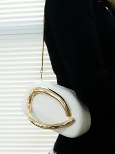 White evening clutch bag with unique gold metallic handle and chic chain strap for women.